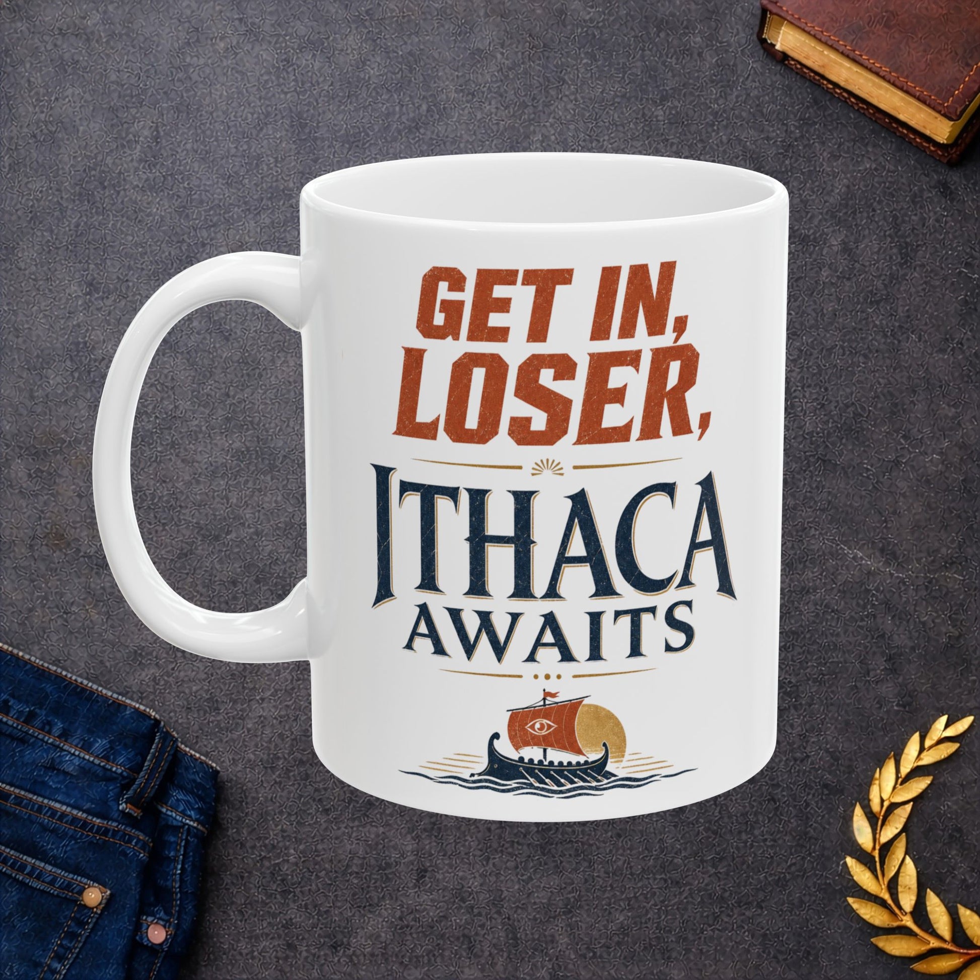 White ceramic mug with a Vintage Greek mythology  design featuring the bold phrase “Get In, Loser, Ithaca Awaits” in distressed orange and navy lettering. An ancient Greek sailing ship crosses dark blue waves beneath a golden sun, creating a humorous Odyssey-inspired design celebrating Odysseus and his journey home to Ithaca.