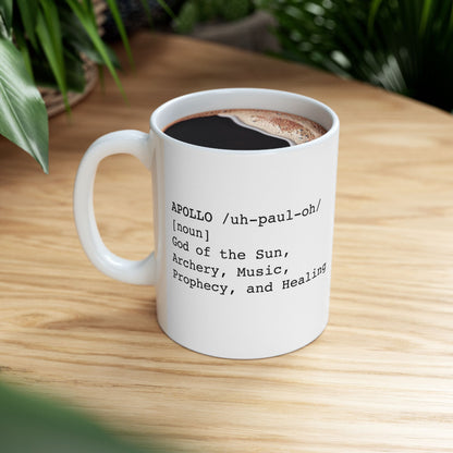 White ceramic mug featuring a dictionary-style definition graphic in black text on a white background. The text reads: 'APOLLO /uh-paul-oh/ [noun] God of the Sun, Archery, Music, Prophecy, and Healing.'