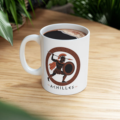 White ceramic mug with a Ancient Greek pottery-style illustration of Achilles, the legendary Trojan War hero, in terracotta orange and black. The warrior wears a crested Corinthian helmet, pleated skirt, and flowing cape while raising a spear in dynamic battle pose. He holds a round shield with Greek key pattern. Enclosed in a circular meander pattern border. The name 'ACHILLES' appears below in geometric letters. Celebrates the hero's legendary martial strength.