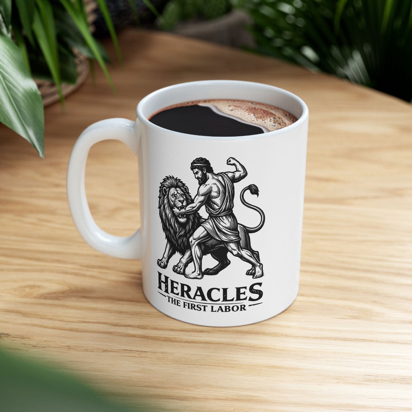 White ceramic mug with a striking black-and-white linocut illustration depicting the Greek hero Heracles wrestling the Nemean Lion. The muscular hero forces his arm into the lion’s open jaws while raising his fist to strike. Below the dynamic scene, bold text reads "HERACLES" followed by a sub-caption that reads "THE FIRST LABOR." The design has a classic, high-contrast vintage woodcut engraving style.