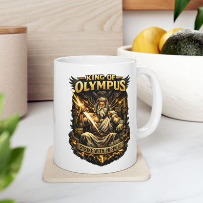 White ceramic mug with a powerful, high-contrast illustration of Zeus seated on a golden throne, holding a brilliantly glowing lightning bolt. He is depicted with a long white beard, stern expression, and muscular build, with a large dark eagle behind him. The bold golden text "KING OF OLYMPUS" arches at the top, and a weathered scroll at the bottom displays the inspiring slogan "STRIKE WITH PURPOSE."