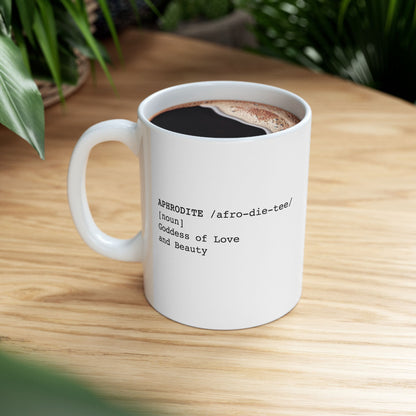 White ceramic mug featuring a dictionary-style definition graphic in black text on a white background. The text reads: 'APHRODITE /afro-die-tee/ [noun] Goddess of Love and Beauty.