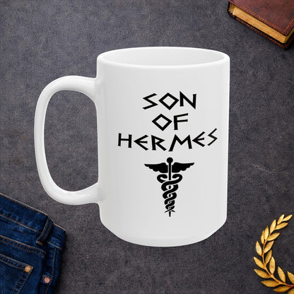 A minimalist black graphic for a white ceramic mug featuring a central caduceus symbol—a winged staff with two snakes entwined around it. Above the symbol, the text "SON OF HERMES" is displayed in a sharp, angular font inspired by ancient Greek stone carvings. The entire design is rendered in a clean, high-contrast black outline.