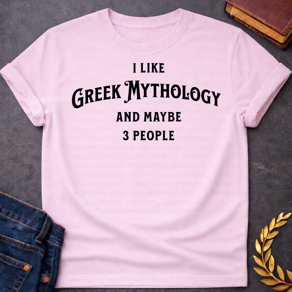 Light Pink t-shirt with A Minimalist typography Greek mythology t-shirt design featuring bold black text that reads, "I Like Greek Mythology and Maybe 3 People." The playful layout uses a mix of vintage-inspired serif and decorative lettering with strong visual hierarchy, creating a humorous design for mythology enthusiasts with an introverted sense of humor.