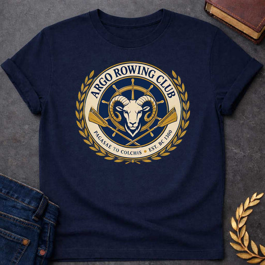 Navy T-shirt with A Nautical emblem of Argo Rowing Club in navy and gold featuring a golden ram's head at center, representing the mythological golden fleece. A ship's wheel rises above, flanked by crossed oars with Greek key patterns. Laurel wreaths frame the circular design. Text reads 'Argo Rowing Club' and 'Pacasae to Colchis Est. BRC 1300.' Celebrates the legendary quest of Jason and the Argonauts with modern rowing club aesthetics and classical maritime imagery.