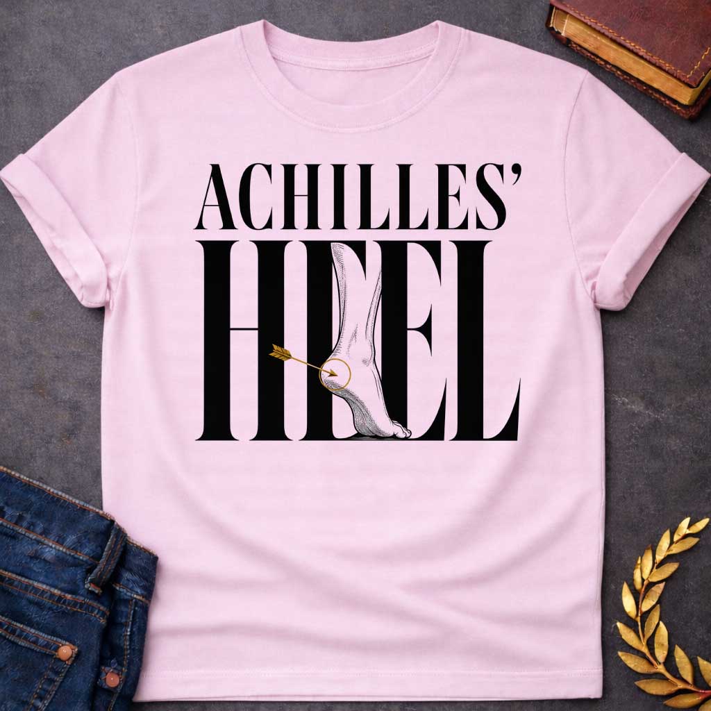 Light Pink t-shirt with Minimalist Greek mythology design featuring bold typography reading "Achilles’ Heel," with an illustrated foot and ankle integrated into the lettering. A golden arrow pierces the heel, highlighted by a circular target detail to symbolize Achilles’ legendary weak spot. The dramatic black, gray, and gold design creates a modern take on the famous myth of Achilles.