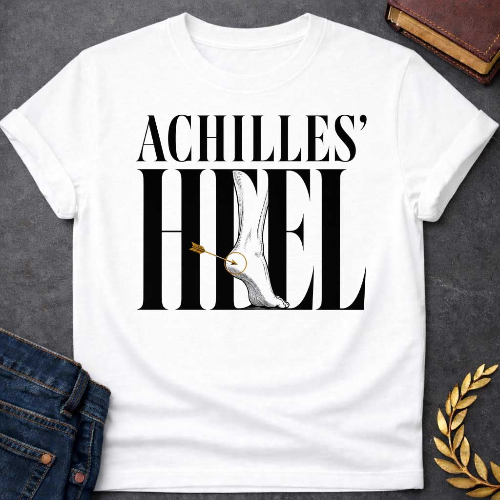 White t-shirt with Minimalist Greek mythology design featuring bold typography reading "Achilles’ Heel," with an illustrated foot and ankle integrated into the lettering. A golden arrow pierces the heel, highlighted by a circular target detail to symbolize Achilles’ legendary weak spot. The dramatic black, gray, and gold design creates a modern take on the famous myth of Achilles.