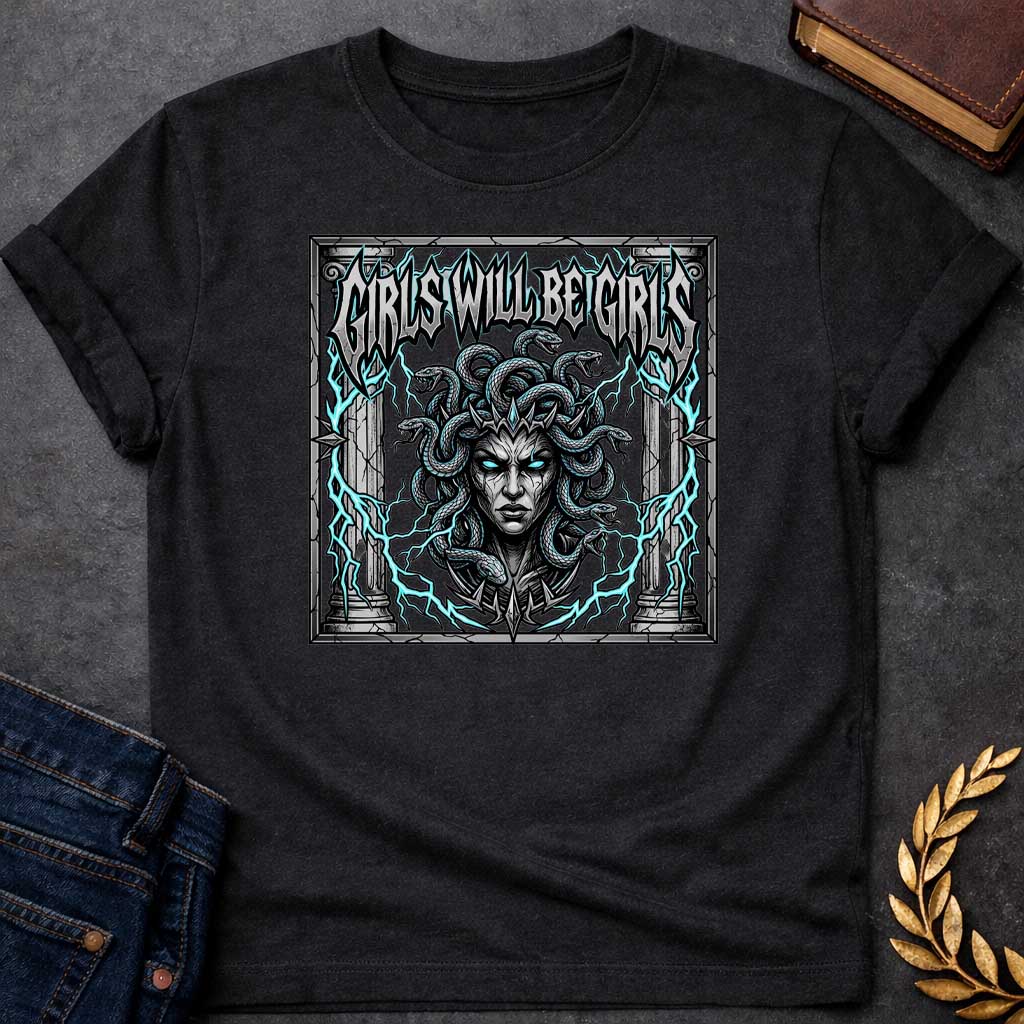 Black T-shirt graphic in a dark heavy metal style featuring a fierce front-facing illustration of Medusa with glowing teal eyes, a spiked crown, and writhing snakes for hair, surrounded by electric teal lightning bolts and flanked by cracked stone Greek columns, all within a crumbling stone frame. Bold metallic gothic lettering across the top reads "Girls Will Be Girls,"