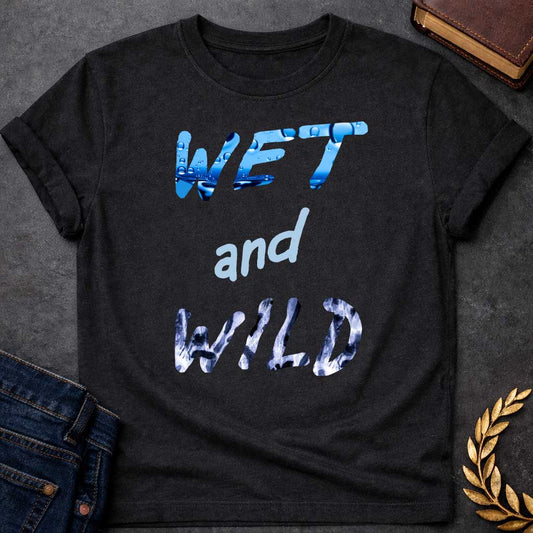 Black T-Shirt with a graphic design featuring the phrase "WET and WILD" in three stacked rows. The word "WET" is at the top in a large, bold, sans-serif font. The letters are filled with a high-definition image of bright blue water and splashing droplets. The word "and" is in the center in a smaller, lowercase, light-blue cursive-style font. The word "WILD" is at the bottom in the same large, bold font as "WET," but the letters are filled with a black-and-white leopard or cheetah print pattern