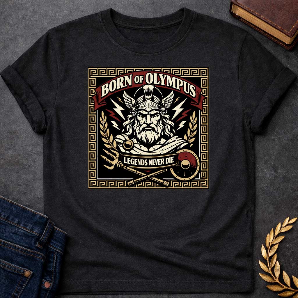 Black T-shirt graphic featuring a bold vintage label-style design with a Greek meander border in gold. A red arched banner at the top reads "Born of Olympus" above a front-facing illustration of Zeus with long white hair and beard wearing a winged helmet, surrounded by radiating lightning bolts and flanked by golden laurel branches. A crossed trident and scepter with a red shield sit below, with a scroll banner reading "Legends Never Die," rendered in black, gold, cream, and red tones