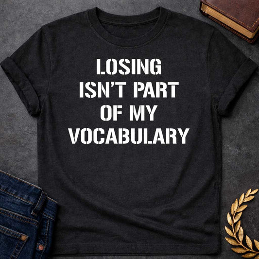 Black T-shirt graphic in white featuring bold military stencil-style text reading "Losing Isn't Part of My Vocabulary" — a motivational phrase referencing Ares, the Greek God of War