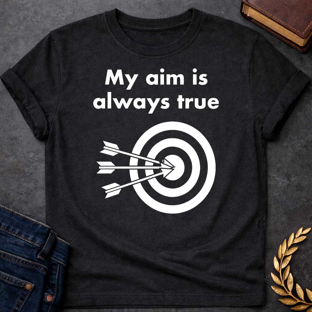 Black T-shirt graphic At the top, the phrase "My aim is always true" is written in a bold, white, sans-serif font across two lines. Below the text is a black and white bullseye target icon. Three white arrows are shown striking the center of the target simultaneously from the left, with their points clustered directly in the "dead center" inner circle