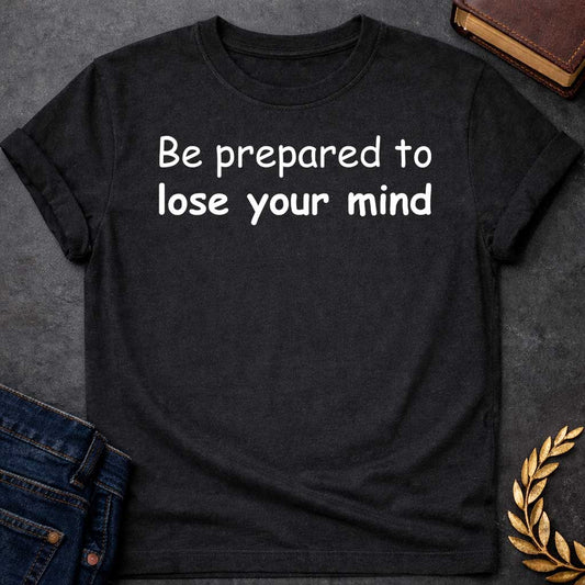 Black T-shirt graphic white text featuring large rounded friendly sans-serif text reading "Be prepared to lose your mind" — a humorous warning referencing Dionysus, the Greek God of Wine and Madness, whose worship was associated with ecstatic frenzy and altered states