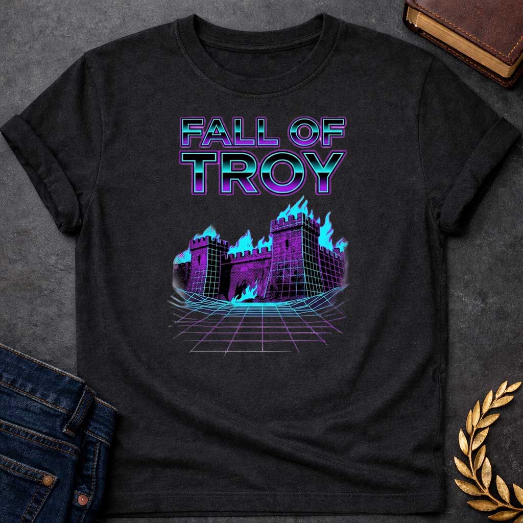 Black T-shirt featuring bold chrome 3D outlined text reading "Fall of Troy" above a retro vaporwave-style illustration of the burning city of Troy depicted as a purple halftone castle engulfed in bright teal flames, set on a glowing teal perspective grid floor — referencing the legendary fall of Troy from Greek mythology, rendered in a vivid 1980s retro synthwave aesthetic in purple and teal tones