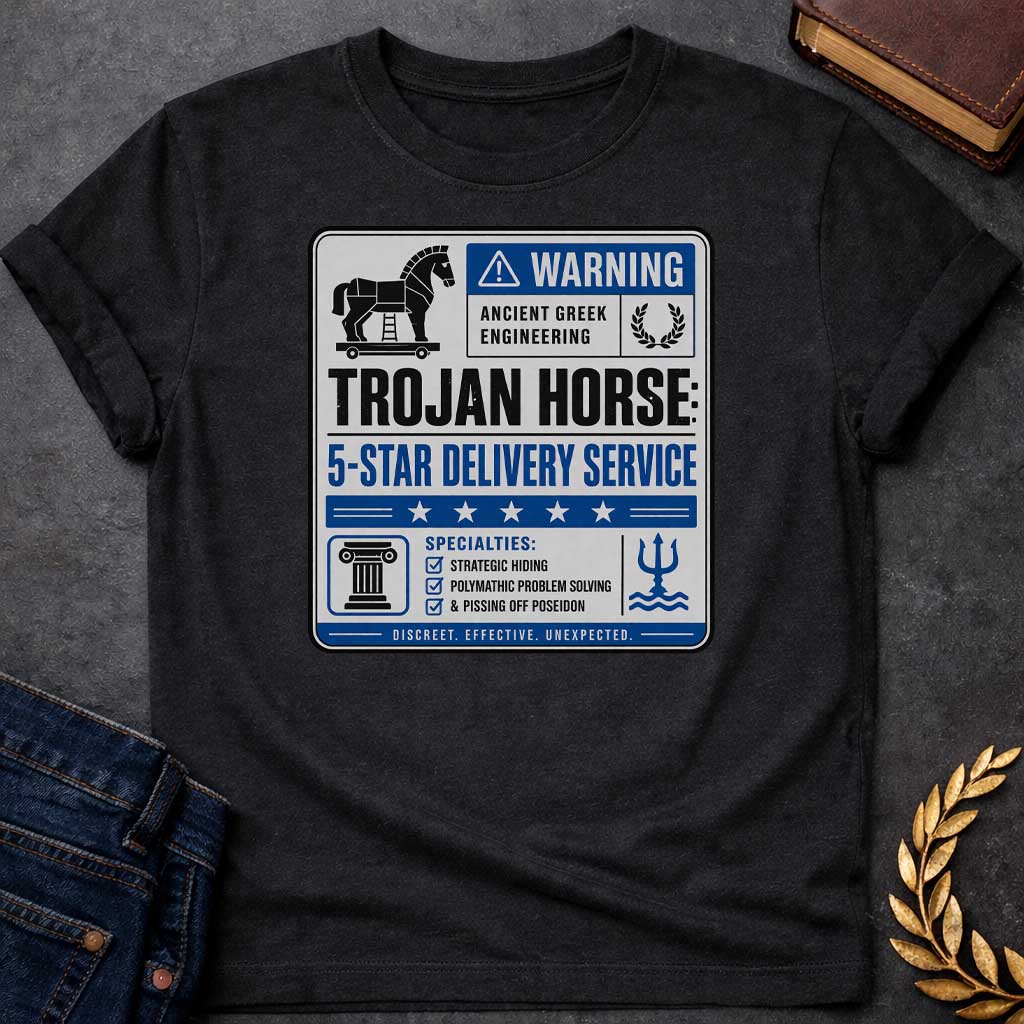 Black T-shirt with a graphic designed as a humorous official-style warning sign in grey, blue, and black featuring a flat Trojan Horse icon with a blue warning triangle and the text "Warning — Ancient Greek Engineering" and a laurel wreath in the top section. Bold text reads "Trojan Horse: 5-Star Delivery Service" above a blue five-star rating banner. A checklist below under "Specialties:" reads "Strategic Hiding, Polymathic Problem Solving, & Pissing Off Poseidon" flanked by a Greek column icon and a Posei