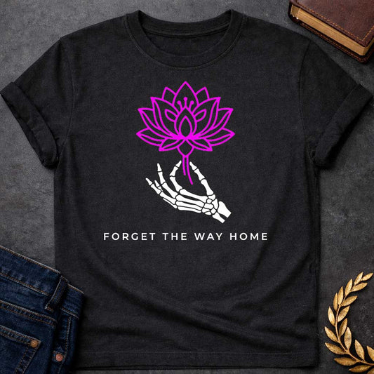 Black T-shirt with a graphic featuring a bold magenta line-art lotus flower held delicately by a white skeletal hand, with spaced bold sans-serif text below reading "Forget the Way Home" — a darkly humorous reference to the Land of the Lotus-Eaters episode in Homer's Odyssey, where Odysseus's crew ate lotus flowers and forgot their desire to return home