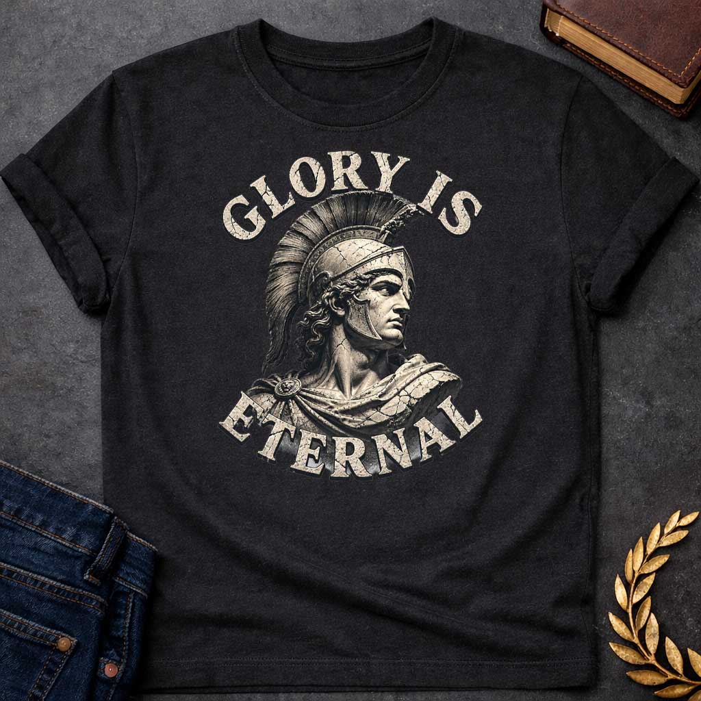 Black T-Shirt with a classical illustration of a Greek warrior in profile, rendered in sepia tones with weathered, cracked texture. The figure wears an ornate Corinthian helmet with black horsehair crest, long curly hair, and armor with a draped cloak. The warrior gazes stoically with classical features. Distressed serif letters spell 'GLORY IS' above and 'ETERNAL' below. The design has a vintage, monumental quality reminiscent of ancient statuary, emphasizing themes of heroism, honor, and timeless legacy.