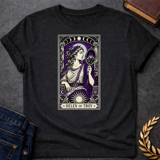 Black T-shirt with an intricate tarot card style graphic featuring Helen of Troy in a Dark Academia aesthetic. She wears a laurel wreath, Greek tunic, and purple robe, holding a hand mirror that reflects a burning city in purple flames. The design has a black, cream, and deep purple color scheme with mystical elements like moon phases, a radiant sun, and an eye symbol. A banner at the bottom reads "HELEN OF TROY" between two stars