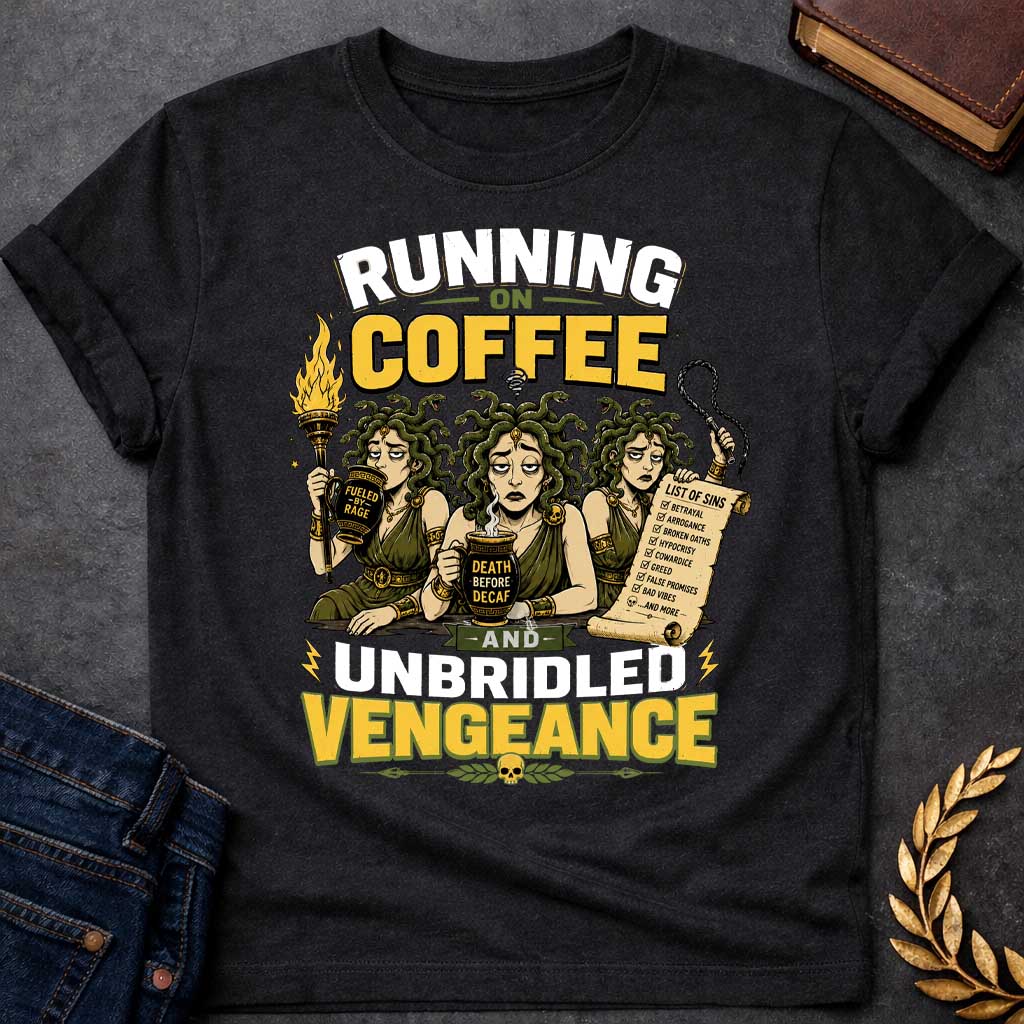 Black T-shirt with a Humorous illustration blending Greek mythology with coffee culture. Three Furies with serpent hair wear classical robes holding symbols of vengeance. Left holds a flaming torch labeled 'Fueled by Rage,' center holds a coffee cup reading 'Death Before Decaf,' right carries a scroll listing sins. Text reads 'Running on Coffee and Unbridled Vengeance' above and below. Gold and black scheme celebrates divine justice powered by caffeine addiction.