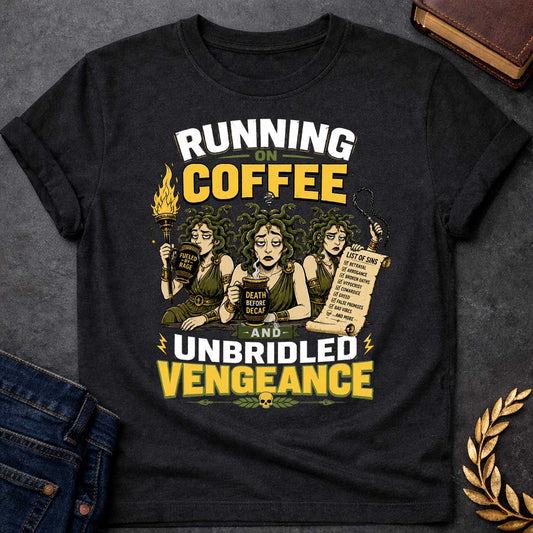 Black T-shirt with a Humorous illustration blending Greek mythology with coffee culture. Three Furies with serpent hair wear classical robes holding symbols of vengeance. Left holds a flaming torch labeled 'Fueled by Rage,' center holds a coffee cup reading 'Death Before Decaf,' right carries a scroll listing sins. Text reads 'Running on Coffee and Unbridled Vengeance' above and below. Gold and black scheme celebrates divine justice powered by caffeine addiction.