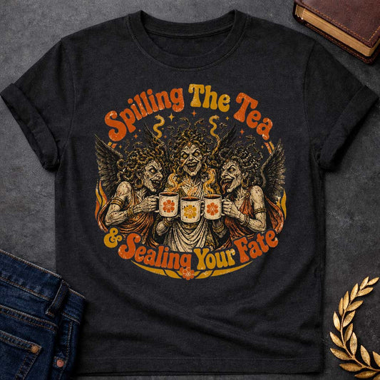 Black T-shirt with a Humorous illustration blending modern gossip culture with Greek mythology. Three Furies with serpent hair and black wings wear classical robes, each holding a decorative tea cup with floral designs. Their expressions are menacing yet mischievous. Text reads 'Spilling The Tea & Sealing Your Fate.' Black, cream, orange, and gold color scheme with decorative flourishes. Playfully references both tea-spilling gossip and divine vengeance and fate.