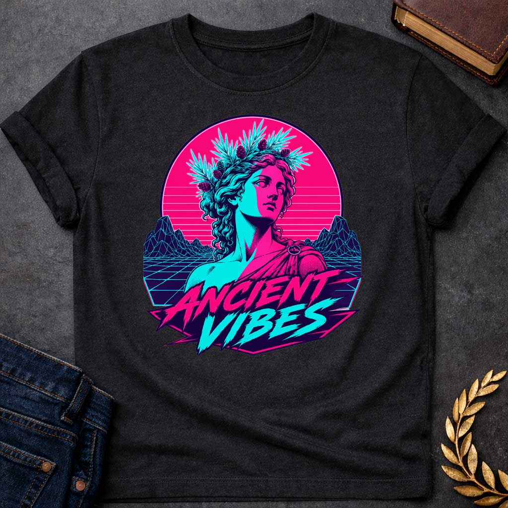 Black T-shirt with a Vaporwave-style illustration of a classical Greek Nymph bust in neon magenta and cyan. The figure wears a laurel wreath crown and draped robes with split-color digital aesthetic. Geometric mountains and grid pattern landscape create a retro 80s vibe. Horizontal scan lines suggest digital distortion. Bold text reads 'ANCIENT VIBES' in magenta and cyan with star accents. Navy blue border frames the design. Blends classical Greek aesthetics with modern synthwave style.