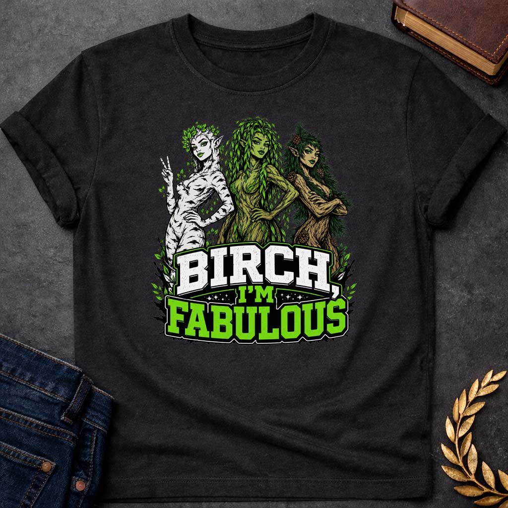 Black T-shirt with a pun-based Greek mythology t-shirt design featuring a detailed engraving-style portrait of a hamadryad emerging from a birch trunk. She has long flowing hair, wears a floral wreath, and looks aside with a dramatic, sassy expression. Arched above her head is the bold black text "BIRCH, I'M FABULOUS" in a clean serif font. The entire graphic uses an elegant, fine-line black and white aesthetic