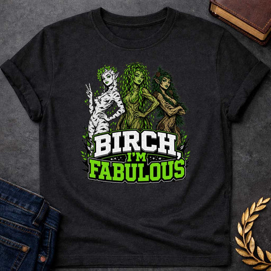 Black T-shirt with a pun-based Greek mythology t-shirt design featuring a detailed engraving-style portrait of a hamadryad emerging from a birch trunk. She has long flowing hair, wears a floral wreath, and looks aside with a dramatic, sassy expression. Arched above her head is the bold black text "BIRCH, I'M FABULOUS" in a clean serif font. The entire graphic uses an elegant, fine-line black and white aesthetic