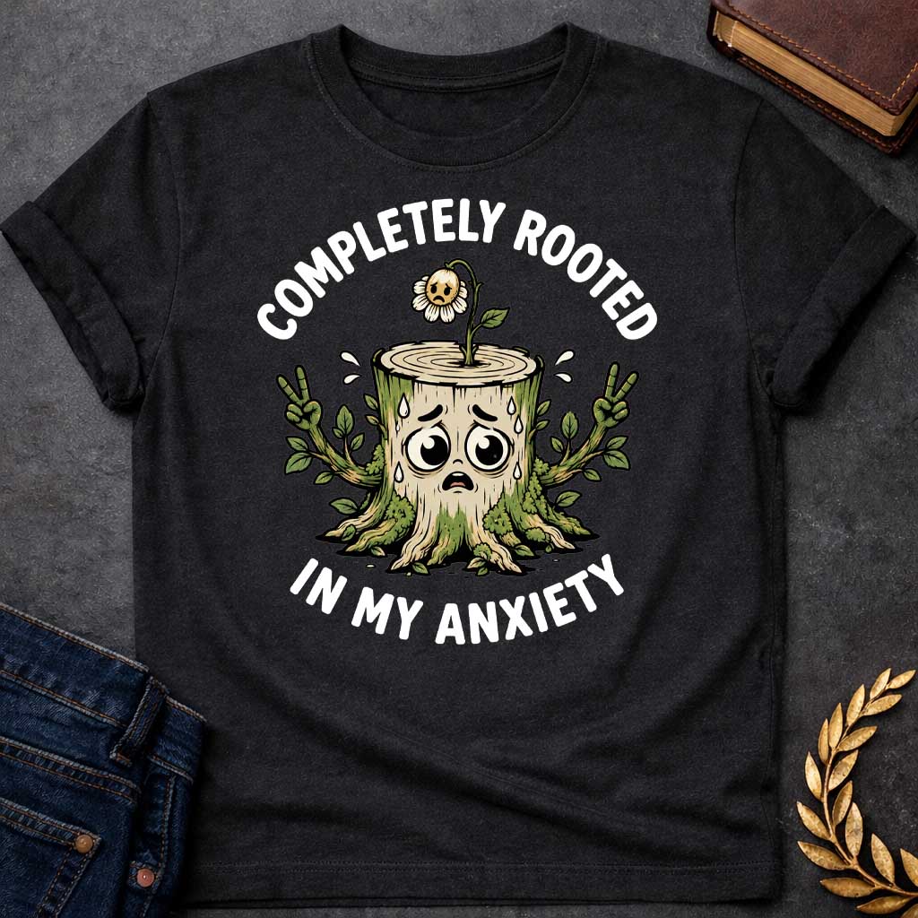 Black T-shirt with a cottagecore-style Greek mythology t-shirt design featuring an engraving illustration of a dryad. The flowing hair intricately weaves into a robust network of tree roots below. Arched elegantly above the portrait is the text "COMPLETELY ROOTED" in a clean white serif font.