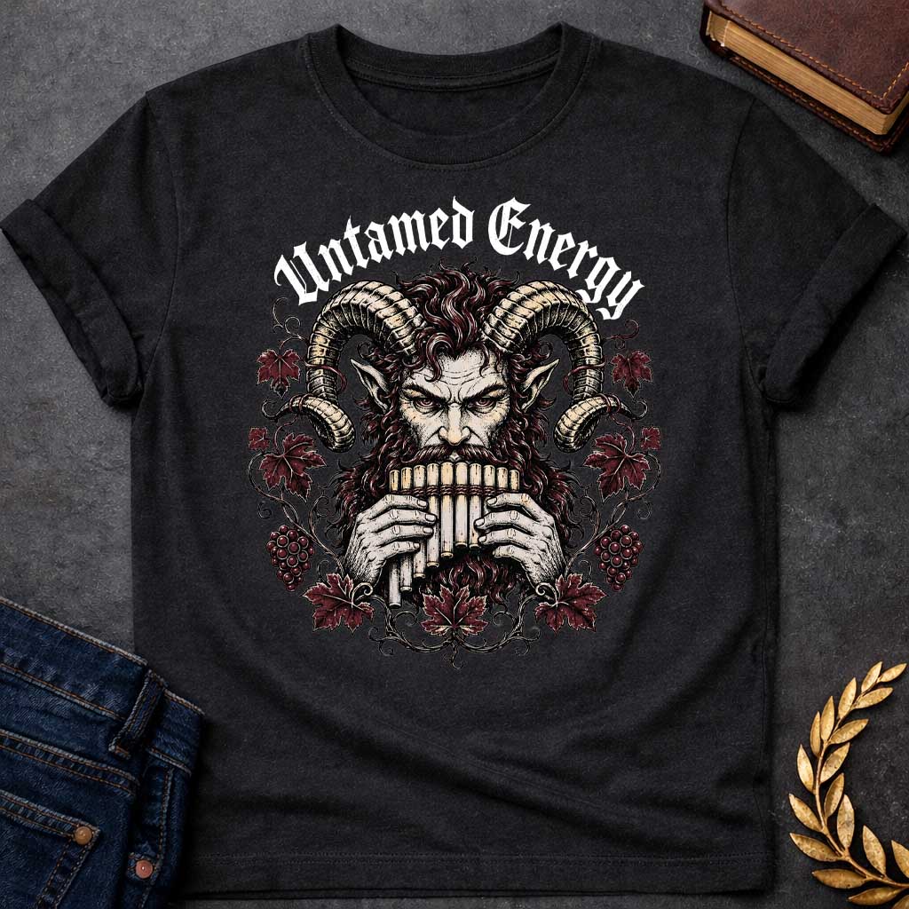Black T-shirt with a heavy metal style t-shirt graphic. It features a powerful, intense satyr or Pan figure with large, curling ram horns playing a pan flute. His fierce face is framed by a circular wreath of detailed, twisting grapevines, deep purple-red autumn leaves, and clusters of grapes. Arched directly above the illustration, the phrase "Untamed Energy" is written in a bold, white gothic font