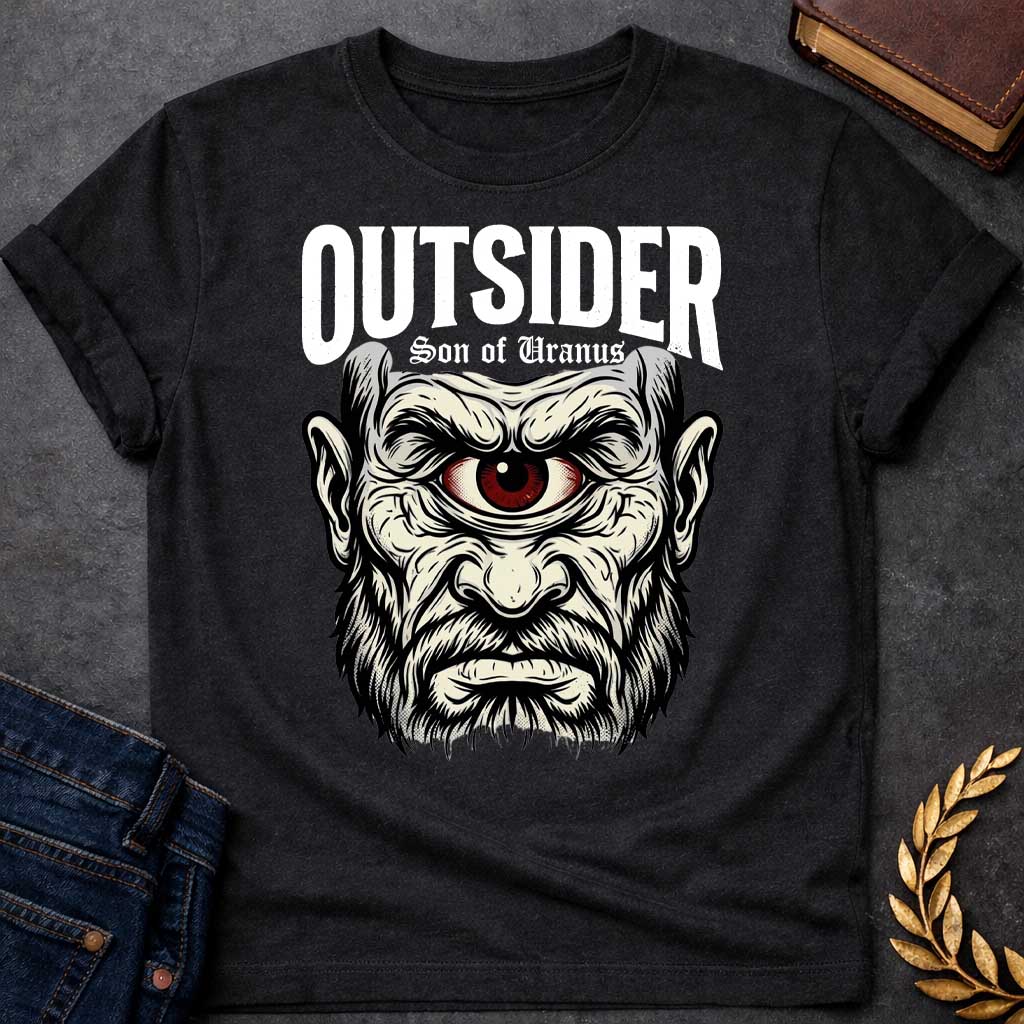 Black T-shirt with a Bold typography design featuring a single-eyed Titan face with fierce expression. Thick white beard and long flowing hair frame a menacing red eye with intense gaze. Black and white engraving style with intricate line work emphasizing the character's otherworldly nature. Text reads 'OUTSIDER' and 'Son of Uranus' referencing the Titans of Greek mythology. Celebrates mythological outsider status, divine rebellion, and powerful, untamed forces beyond mortal comprehension.