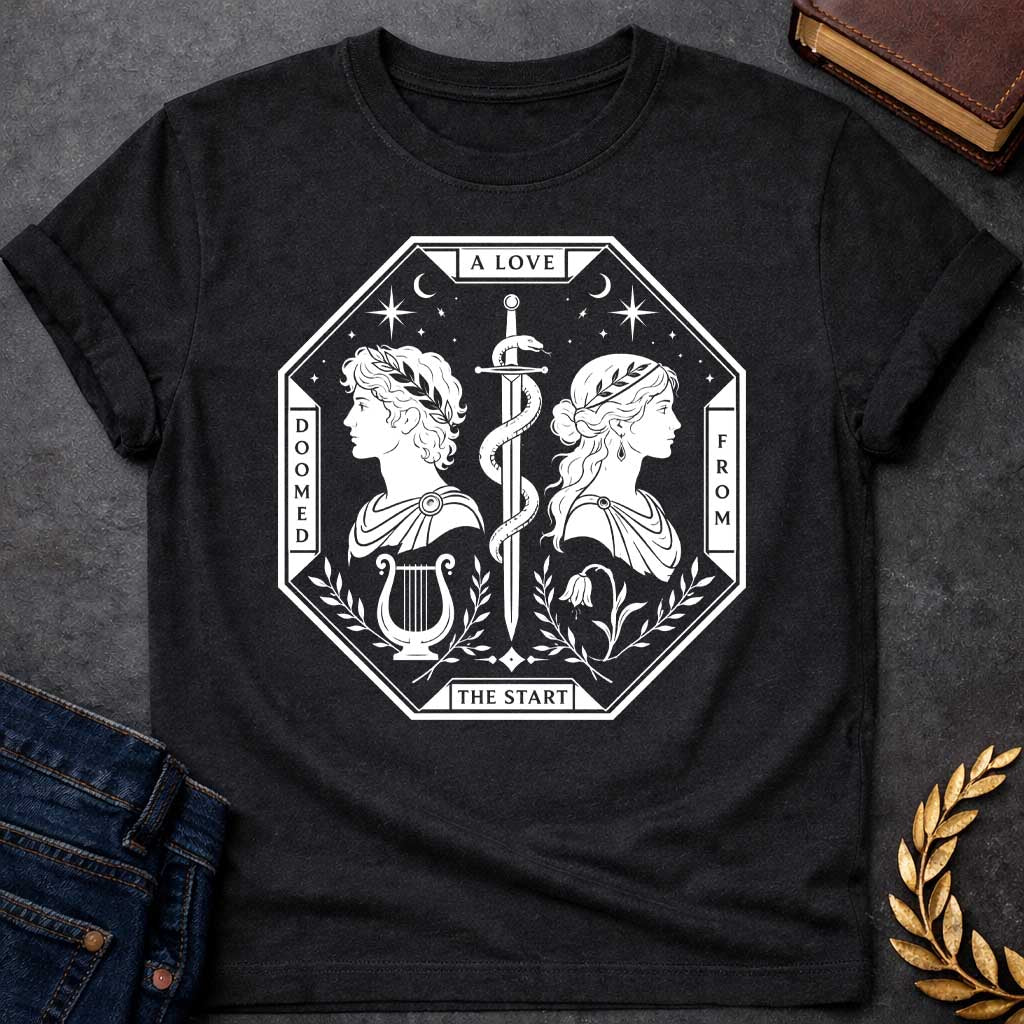 Black t-shirt in white tarot-card style: an octagonal frame shows two facing silhouette profiles (a laurel-crowned man and a woman with a headband) separated by a snake-entwined sword. Below them sit a lyre and a drooping flower, framed by olive branches, stars, and crescent moons, evoking Orpheus and Eurydice.