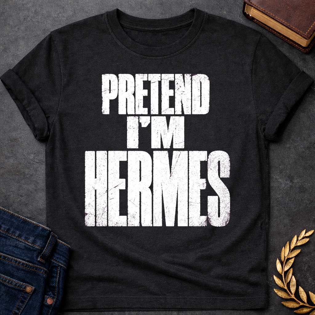 Black t-shirt with a Pretend I’m Hermes Greek mythology  design featuring bold distressed white typography on a transparent background. The stacked text reads “PRETEND I’M HERMES” in a rugged vintage block font, creating a humorous design inspired by Hermes, the Greek god of travel, messengers, trade, and trickery.