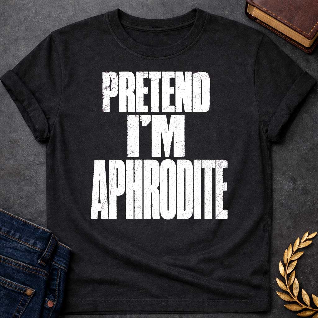 Black t-shirt with a Pretend I’m Aphrodite Greek mythology design featuring bold distressed white typography on a transparent background. The stacked text reads “PRETEND I’M APHRODITE” in a rugged vintage block font, creating a simple humorous design inspired by Aphrodite, the Greek goddess of love and beauty.