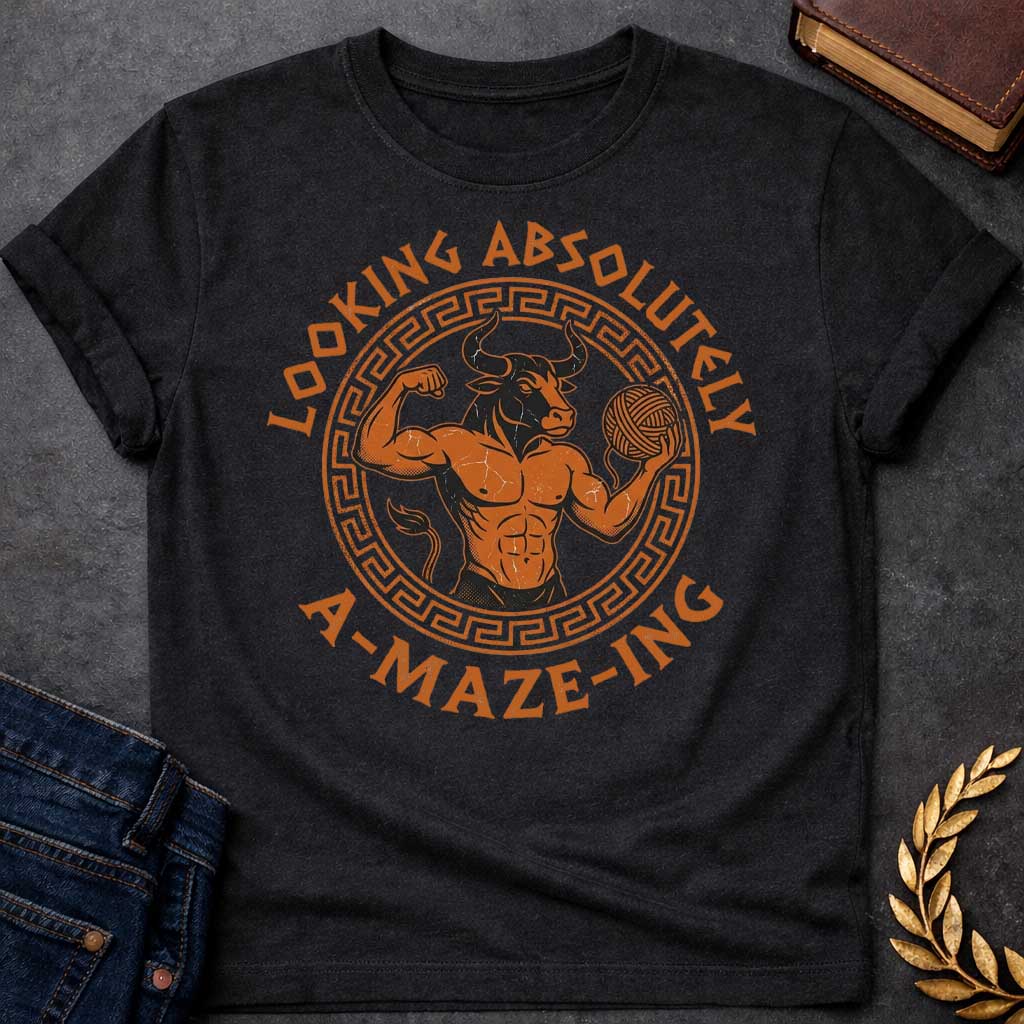 Black T-shirt with a Fitness-themed design of a muscular Minotaur displaying impressive abdominal definition and flexing one arm. The bull-headed figure holds a ball of yarn in the other hand, referencing the mythological thread used to escape the labyrinth. Terracotta orange and brown coloring with defined musculature. Greek key pattern border frames the circular composition. Text reads 'Looking Absolutely A-Maze-Ing' in bold black lettering. Clever wordplay blends gym culture with Greek mythology.