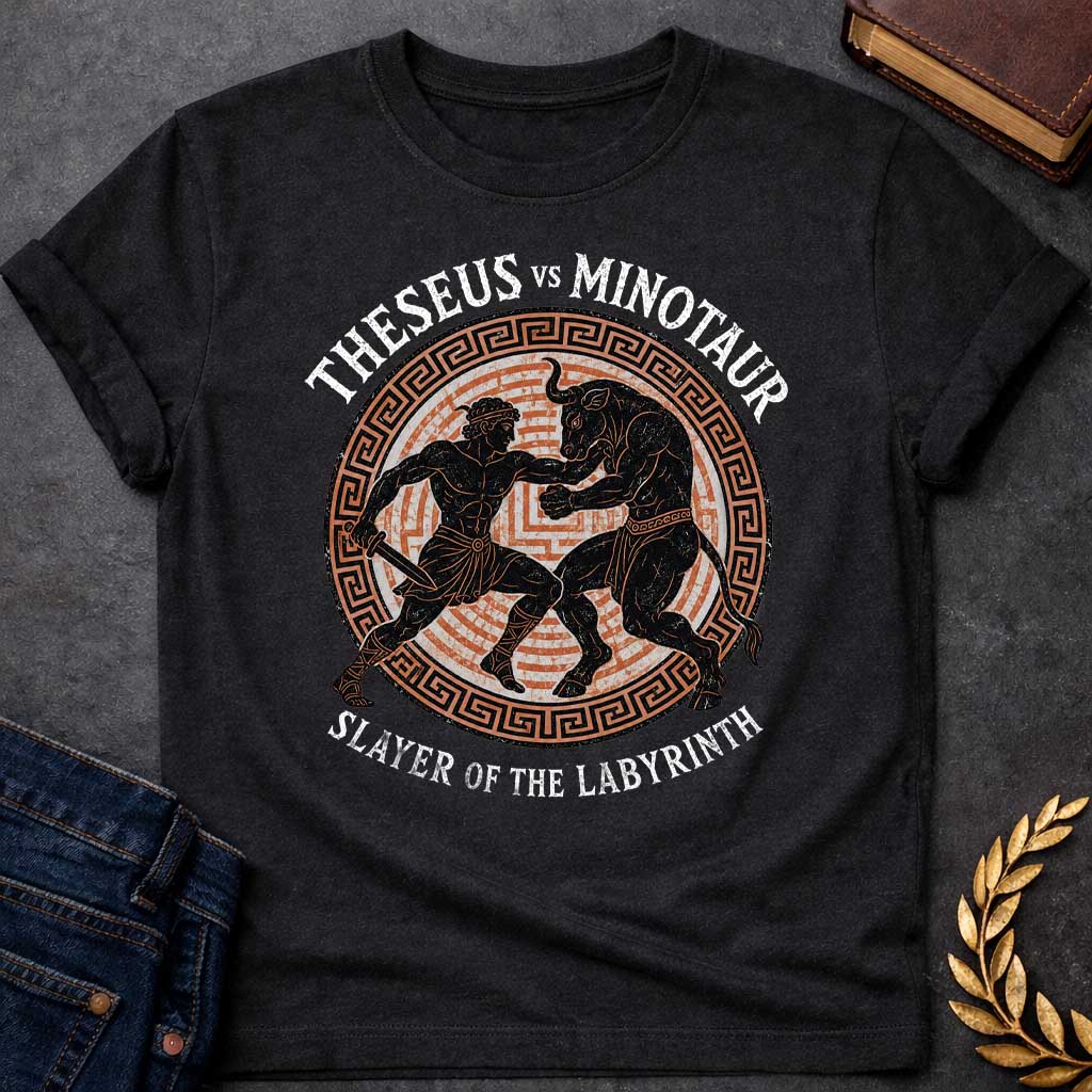 Black T-shirt with A vintage, Greek pottery-style graphic depicting a battle. At the center, the muscular hero Theseus holds a sword as he wrestles the powerful Minotaur. The black figure silhouettes are set against an orange labyrinth pattern inside a circular frame with a Greek key border. Distressed text reads "THESEUS VS MINOTAUR" arched across the top and "SLAYER OF THE LABYRINTH" curved along the bottom.