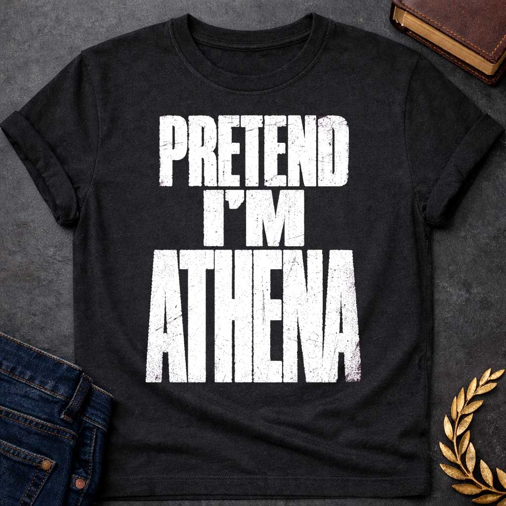 Black t-shirt with a Pretend I’m Athena Greek mythology design featuring bold distressed white typography on a transparent background. The stacked text reads “PRETEND I’M ATHENA” in a rugged vintage block font, creating a humorous design inspired by Athena, the Greek goddess of wisdom, warfare, strategy, and crafts.