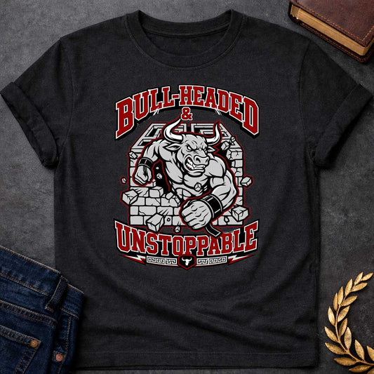 Black T-shirt with a High-impact sports design featuring a muscular Minotaur bursting through a crumbling stone wall in red, gray, and white. The aggressive bull-headed figure displays defined musculature and determination. Text reads 'Bull-Headed & Unstoppable' in bold red and black lettering. Greek key pattern and bull symbol anchor the bottom. Combines Greek mythology with modern gym and sports culture, celebrating stubborn strength and unstoppable power.