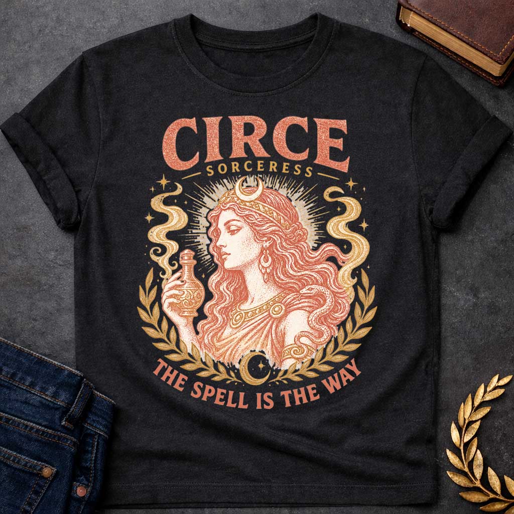Black t-shirt with a Vintage Greek mythology design featuring Circe, the legendary sorceress, holding a potion bottle with a snake coiled around her arm. Crescent moons, stars, mystical smoke, and laurel branches frame the portrait with the text “Circe Sorceress” and “The Spell Is the Way” in a distressed antique style.