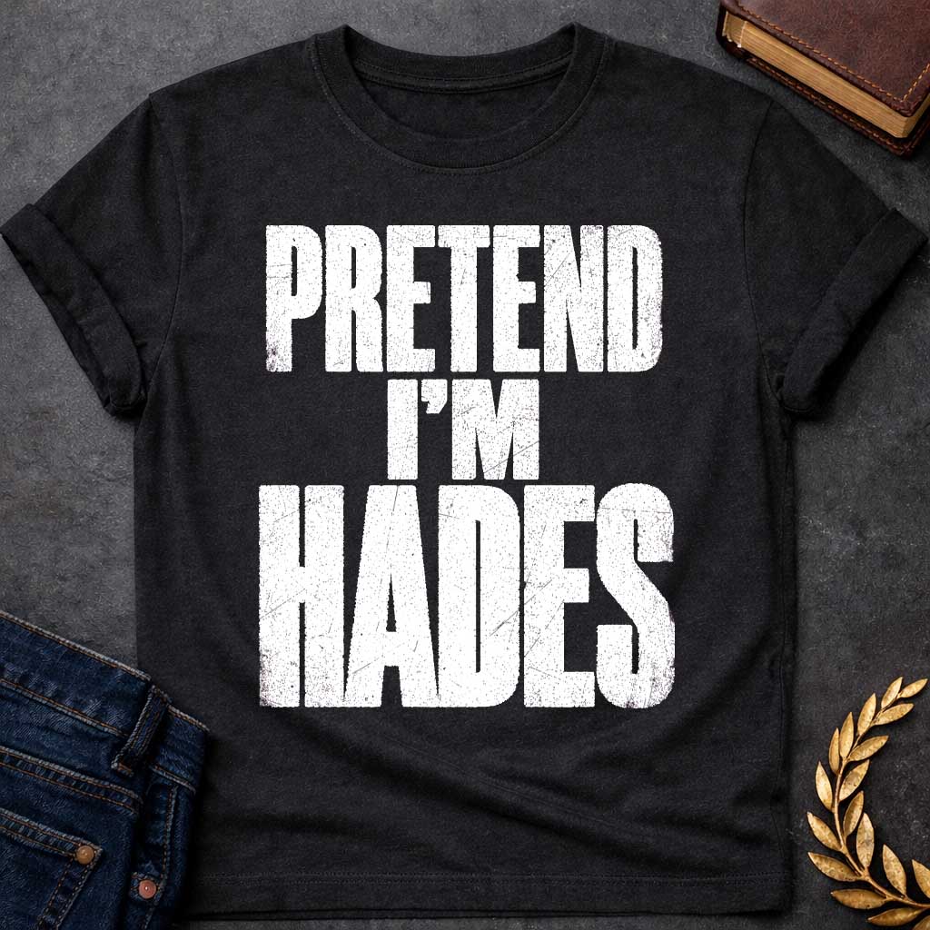 Black t-shirt with a Pretend I’m Hades Greek mythology design featuring bold distressed white typography on a transparent background. The stacked text reads “PRETEND I’M HADES” in a rugged vintage block font, creating a humorous design inspired by Hades, the Greek god of the underworld, the dead, and riches.