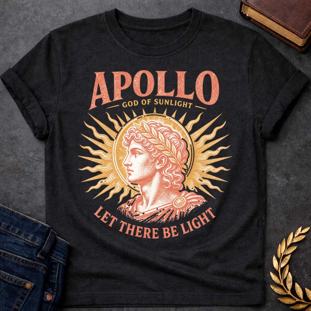 Black t-shirt with a Vintage Greek mythology design featuring Apollo, god of sunlight, in a classical portrait wearing a laurel crown. A radiant golden sunburst frames the god in warm coral and gold engraving-style artwork. Bold text reads "Apollo – God of Sunlight" and "Let There Be Light," celebrating the legendary Olympian god.