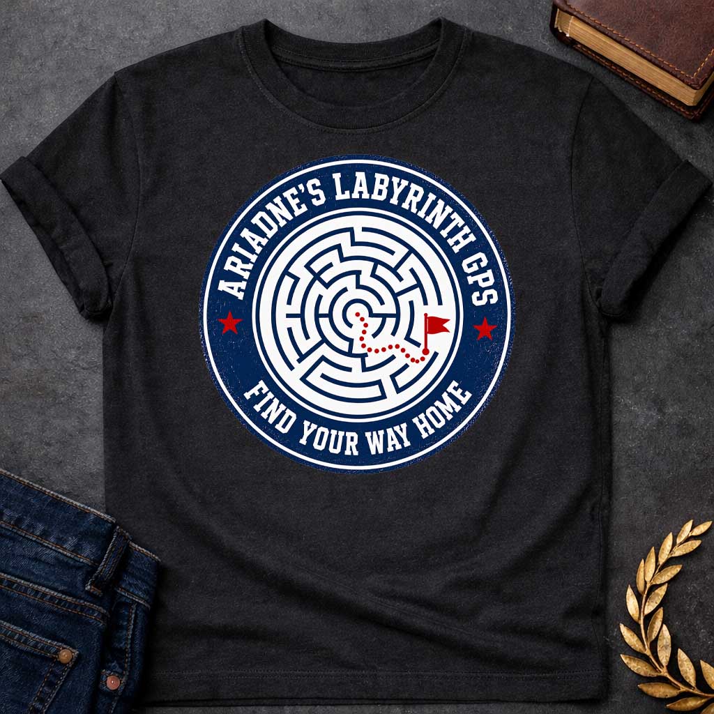 Black T-shirt with A Circular emblem with concentric maze in navy and white, featuring a red dotted path through the labyrinth toward a flag marker. Red stars accent the design. Text reads 'Ariadne's Labyrinth GPS' around the border and 'Find Your Way Home' below. Merges Greek mythology with modern GPS technology, presenting the legendary thread as contemporary guidance. Celebrates finding home through challenging mazes.
