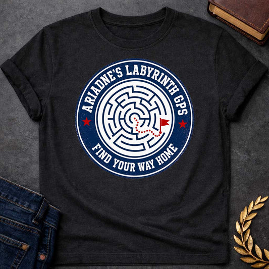 Black T-shirt with A Circular emblem with concentric maze in navy and white, featuring a red dotted path through the labyrinth toward a flag marker. Red stars accent the design. Text reads 'Ariadne's Labyrinth GPS' around the border and 'Find Your Way Home' below. Merges Greek mythology with modern GPS technology, presenting the legendary thread as contemporary guidance. Celebrates finding home through challenging mazes.

