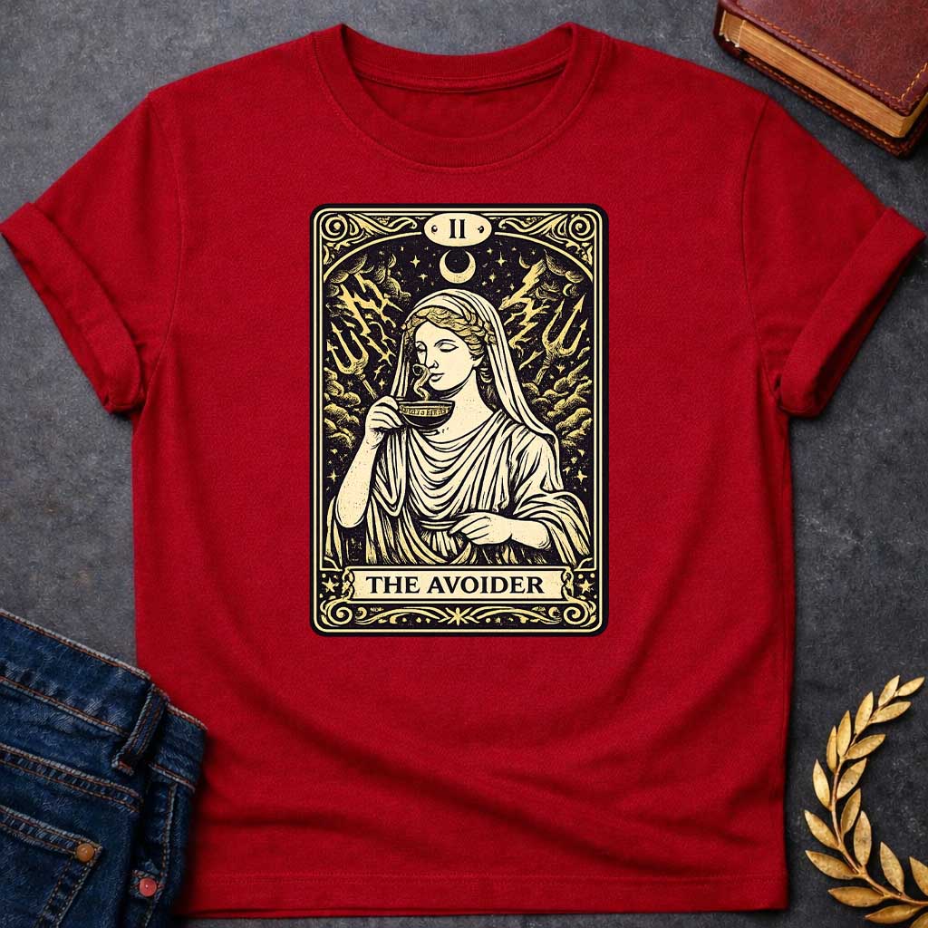 Red T-shirt design in the style of a vintage tarot card. It features a woman in classical Greek robes calmly sipping from a cup. Behind her, lightning strikes and two tridents emerge from turbulent clouds under a crescent moon. The card is labeled with Roman numeral "II" at the top and the text "THE AVOIDER" in a banner at the bottom, all rendered in a cream and black woodcut aesthetic.