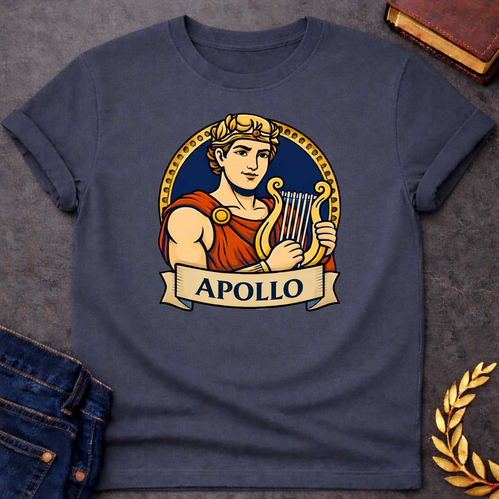 Dark Heather T-shirt graphic featuring a vibrant illustrated portrait of Apollo, the Greek God of the Sun and Music, with short curly hair and a gold laurel crown, wearing a red draped robe fastened with a gold brooch, playing a golden lyre. He is framed within a gold circular border against a navy background, with a scroll banner below reading "Apollo," in a bold tattoo-inspired style with navy, gold, and red tones
