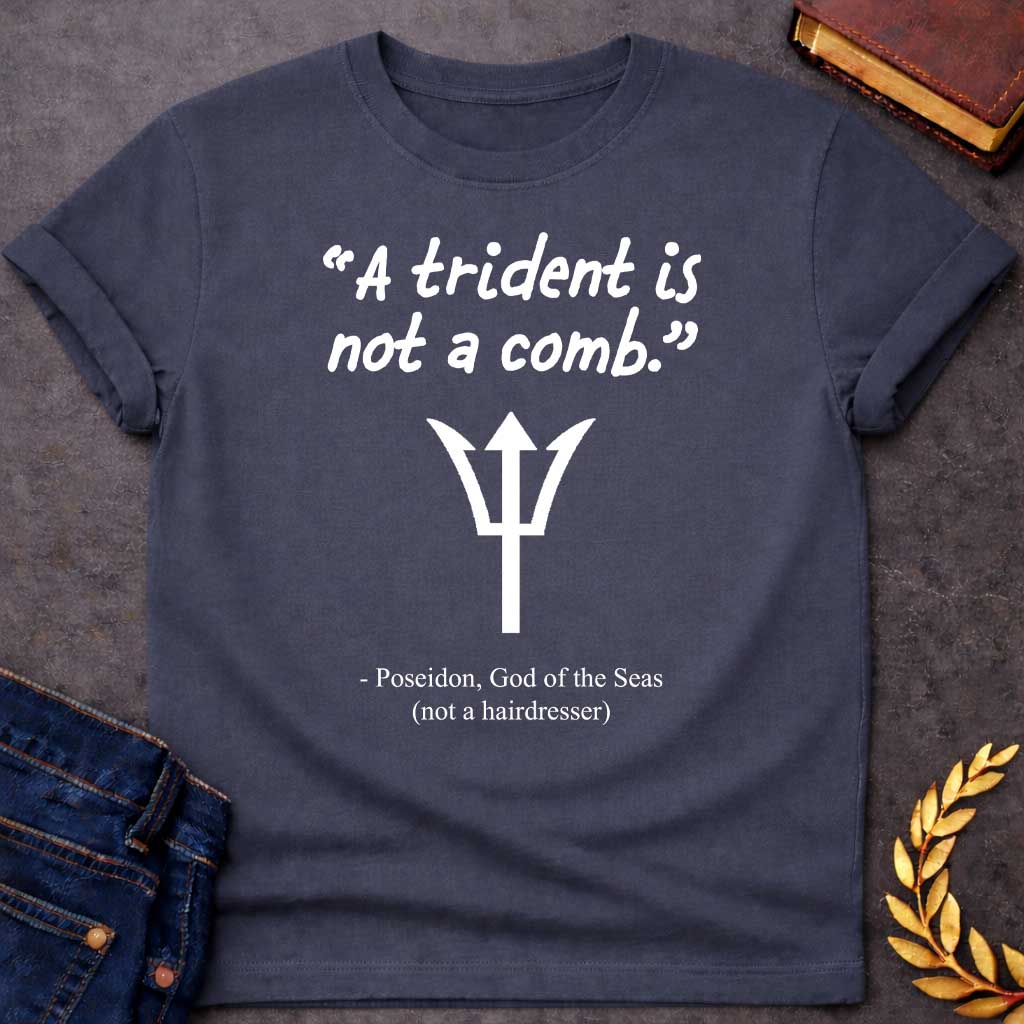 Dark Heather T-shirt graphic featuring a white handwritten-style quote reading "A trident is not a comb." above a flat white trident symbol, with the humorous attribution below in clean serif text reading "- Poseidon, God of the Seas (not a hairdresser)