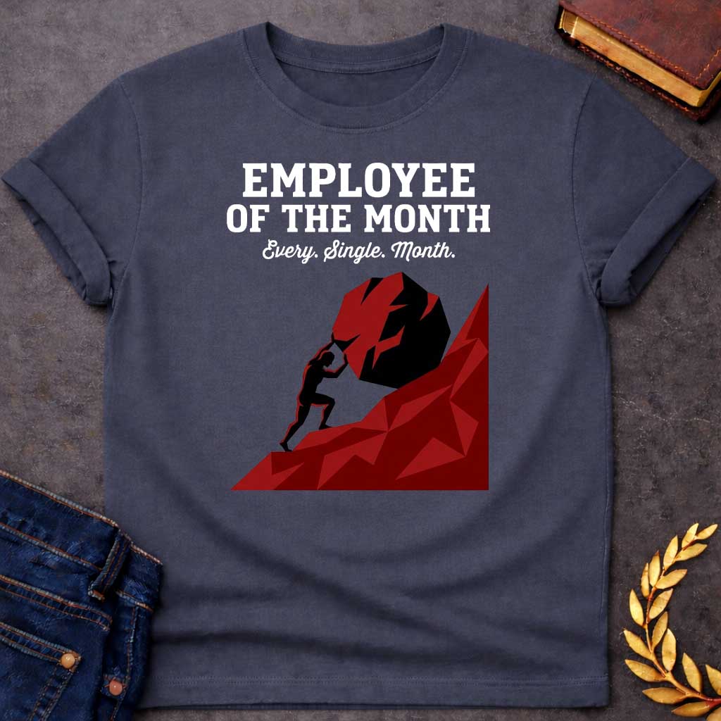 Dark Heather T-shirt with a graphic featuring bold dark grey slab serif text reading "Employee of the Month" with a script subtitle reading "Every. Single. Month." above a low-polygon geometric illustration of Sisyphus as a black silhouette straining to push an enormous dark red boulder up a steep angular red hill — a humorous reference to the Greek myth of Sisyphus, condemned to roll a boulder uphill for eternity