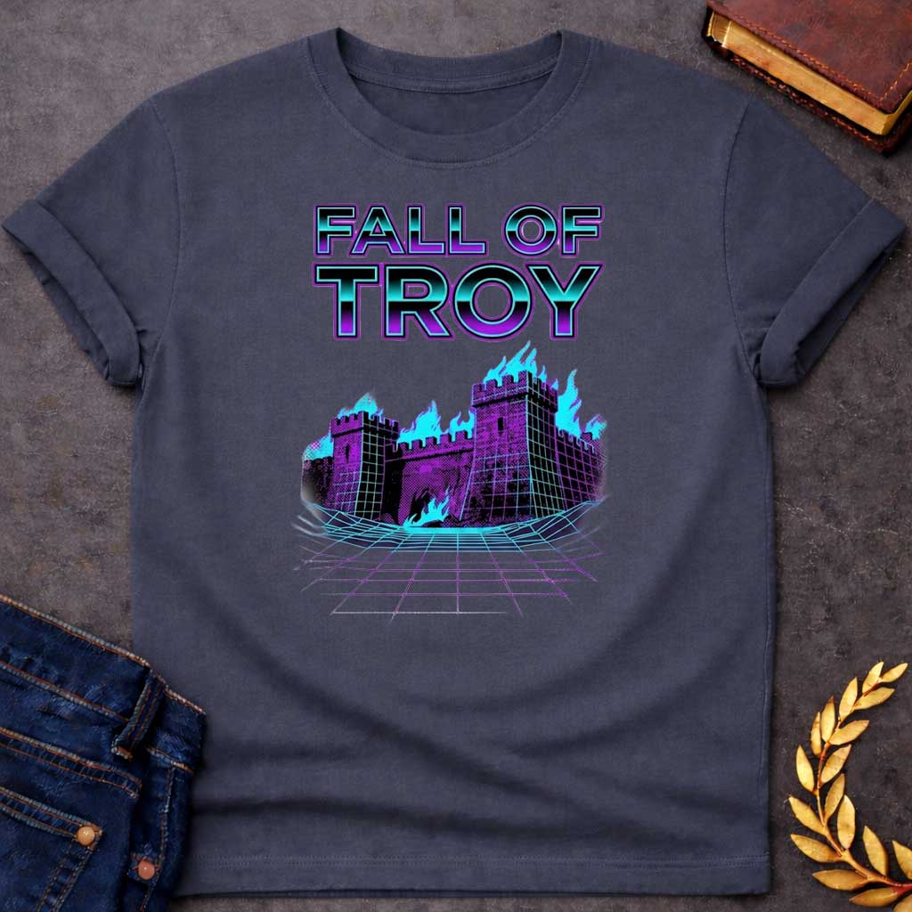 Dark Heather T-shirt featuring bold chrome 3D outlined text reading "Fall of Troy" above a retro vaporwave-style illustration of the burning city of Troy depicted as a purple halftone castle engulfed in bright teal flames, set on a glowing teal perspective grid floor — referencing the legendary fall of Troy from Greek mythology, rendered in a vivid 1980s retro synthwave aesthetic in purple and teal tones