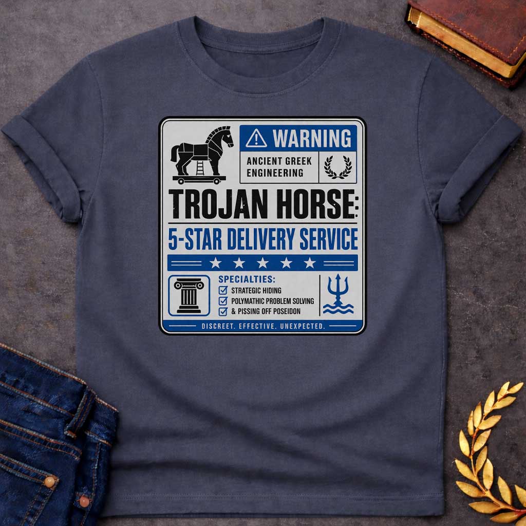 Dark Heather T-shirt with a graphic designed as a humorous official-style warning sign in grey, blue, and black featuring a flat Trojan Horse icon with a blue warning triangle and the text "Warning — Ancient Greek Engineering" and a laurel wreath in the top section. Bold text reads "Trojan Horse: 5-Star Delivery Service" above a blue five-star rating banner. A checklist below under "Specialties:" reads "Strategic Hiding, Polymathic Problem Solving, & Pissing Off Poseidon" flanked by a Greek column icon and