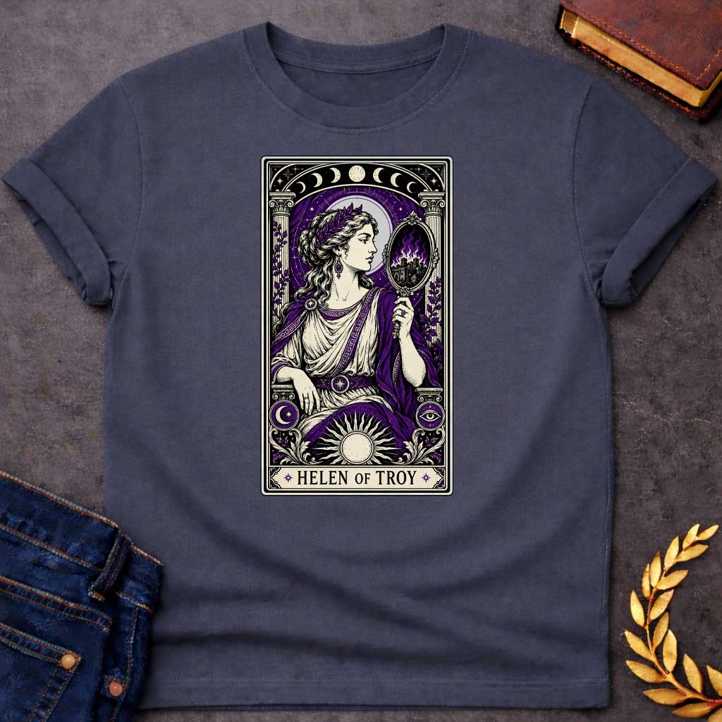 Dark Heather T-shirt with an intricate tarot card style graphic featuring Helen of Troy in a Dark Academia aesthetic. She wears a laurel wreath, Greek tunic, and purple robe, holding a hand mirror that reflects a burning city in purple flames. The design has a black, cream, and deep purple color scheme with mystical elements like moon phases, a radiant sun, and an eye symbol. A banner at the bottom reads "HELEN OF TROY" between two stars